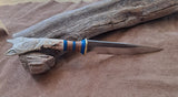 25-9 - Wolf Face with Celtic Knot Carved Deer Antler Blue Paper Micarta, Stabilized Silky Oak Drop Point Utility